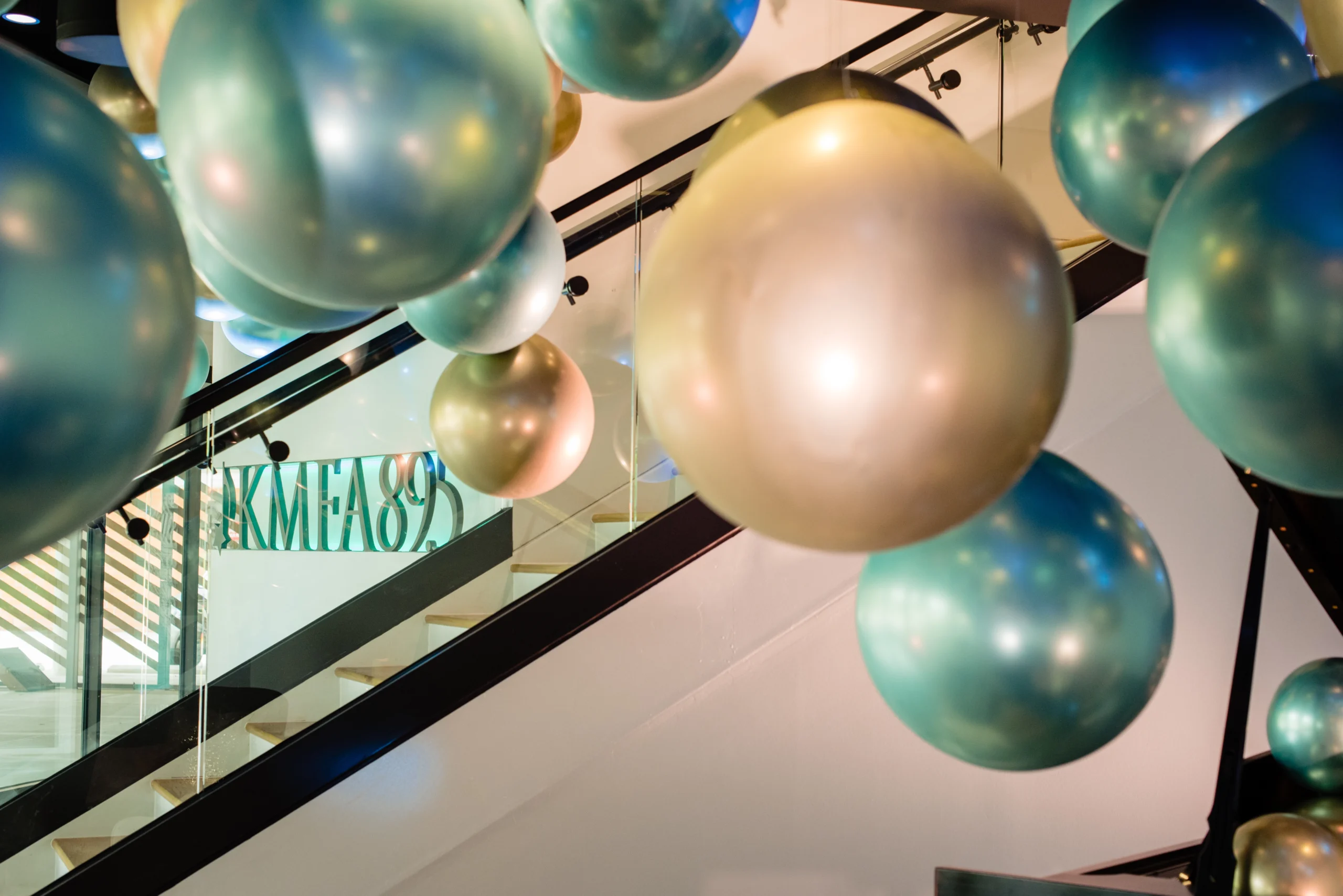 The KMFA event space lobby with metallic balloons